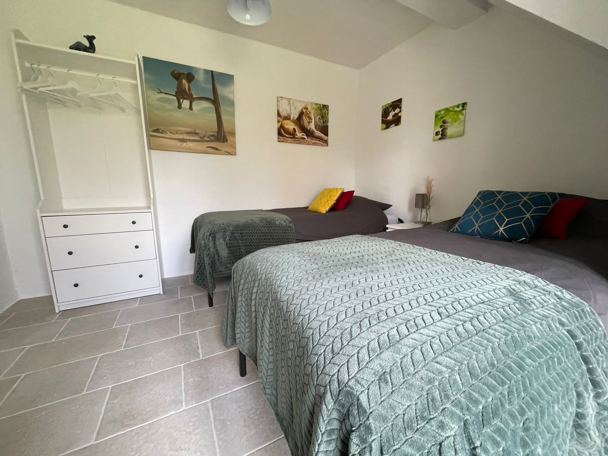 Slaapkamer met twee bedden en groene dekens